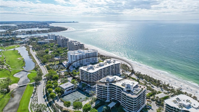 birds eye view of property featuring a beach view and a water view