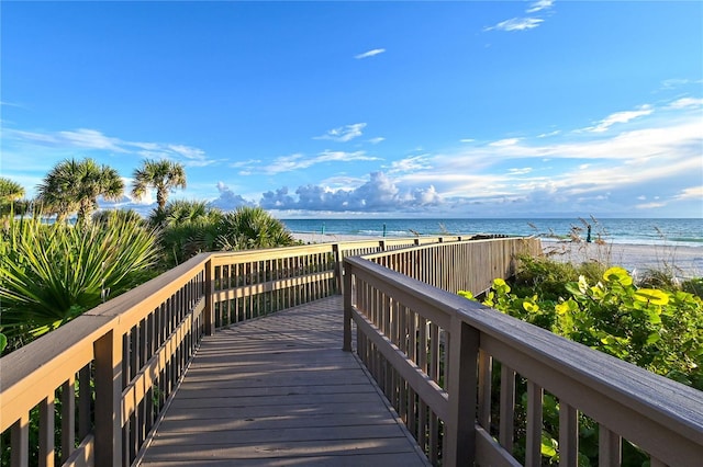 surrounding community featuring a beach view and a water view