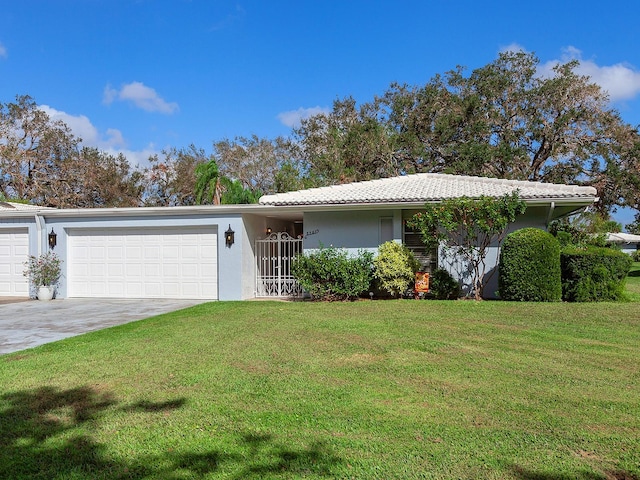 ranch-style house featuring a front yard and a garage