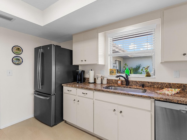 kitchen with white cabinets, dark stone countertops, sink, and appliances with stainless steel finishes