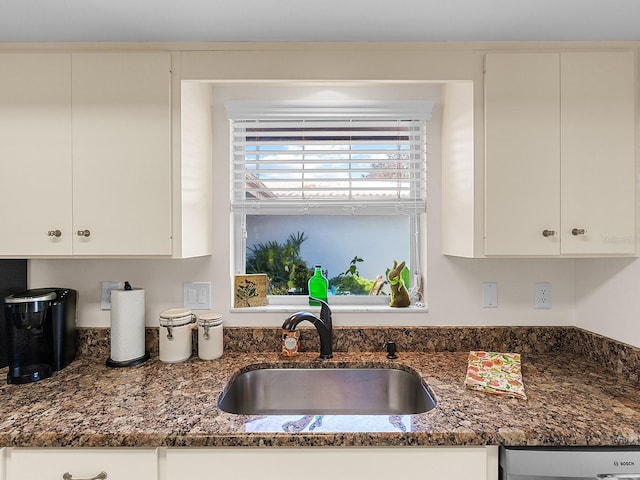 kitchen featuring sink and white cabinets