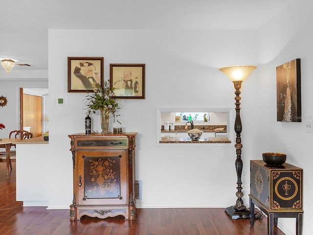 hallway with dark hardwood / wood-style flooring