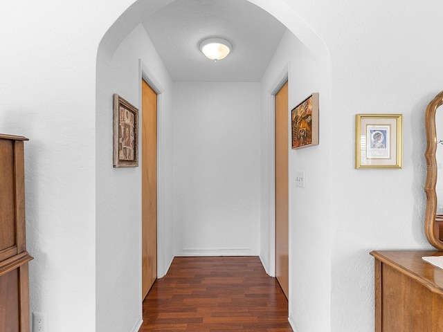 hallway with dark wood-type flooring