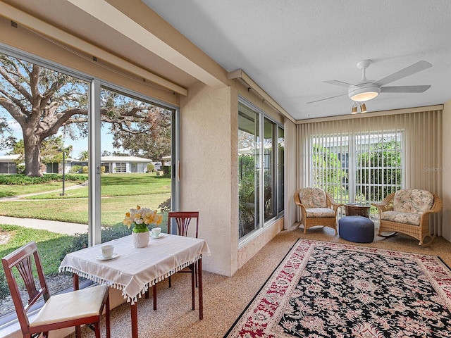 sunroom with ceiling fan