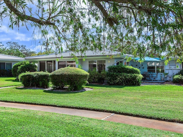 ranch-style house with a front lawn