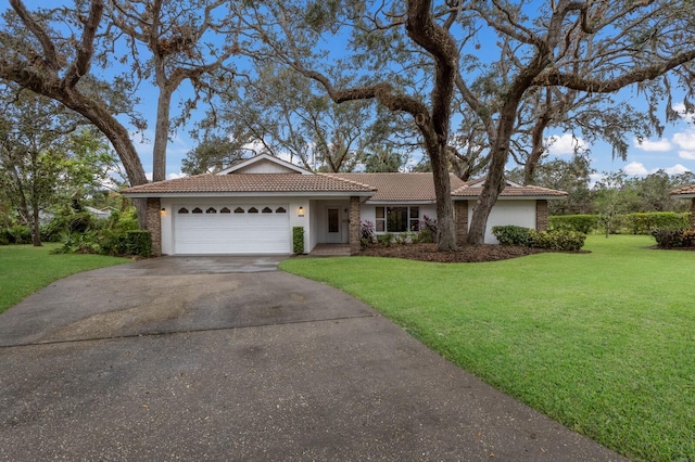 ranch-style home featuring a garage and a front lawn