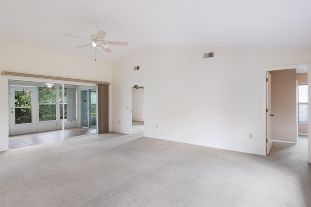 spare room featuring ceiling fan, light colored carpet, and lofted ceiling