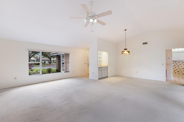 unfurnished living room with ceiling fan, light colored carpet, and lofted ceiling