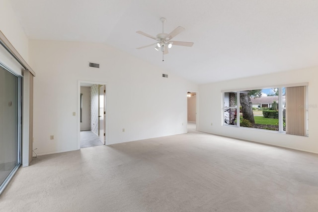 unfurnished living room with ceiling fan, light colored carpet, and lofted ceiling