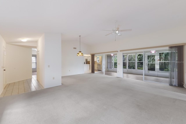 unfurnished living room featuring light colored carpet, ceiling fan, and lofted ceiling