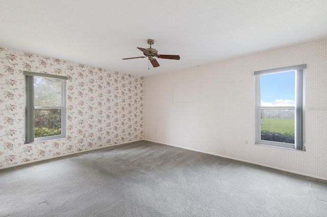 carpeted spare room with ceiling fan