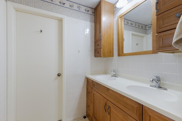 bathroom featuring tasteful backsplash, vanity, and tile walls