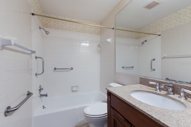 full bathroom featuring vanity, toilet, and tiled shower / bath