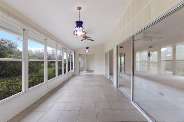 unfurnished sunroom featuring ceiling fan and vaulted ceiling