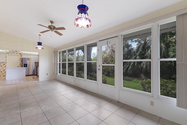 unfurnished sunroom with ceiling fan and vaulted ceiling