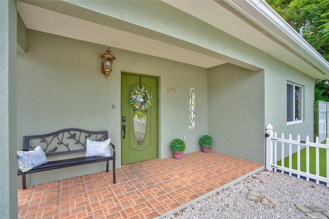 view of exterior entry featuring a patio area