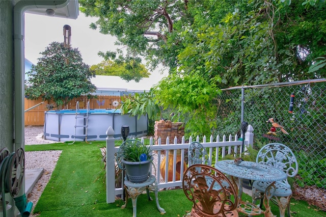 view of yard featuring a fenced in pool