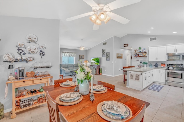 dining room featuring light tile patterned flooring, ceiling fan, and vaulted ceiling