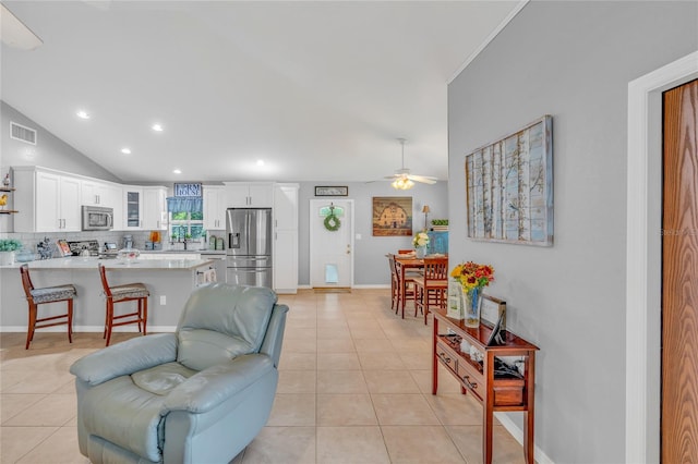 tiled living room with vaulted ceiling and ceiling fan