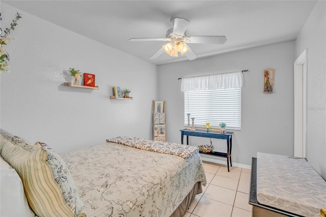 tiled bedroom featuring ceiling fan