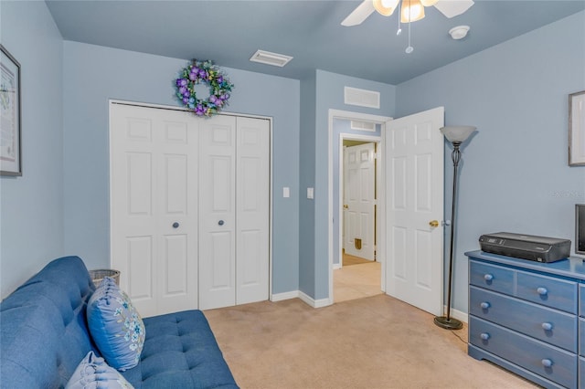 living area featuring ceiling fan and light carpet