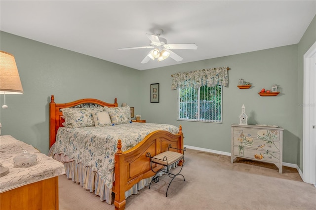 bedroom featuring light colored carpet and ceiling fan