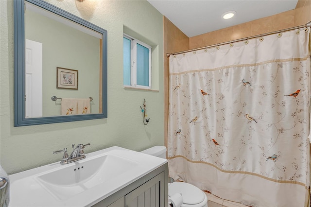 bathroom featuring vanity, toilet, and a shower with shower curtain