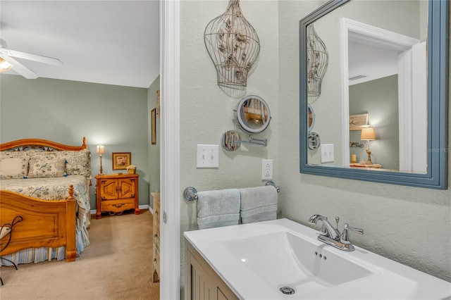 bathroom with ceiling fan and vanity