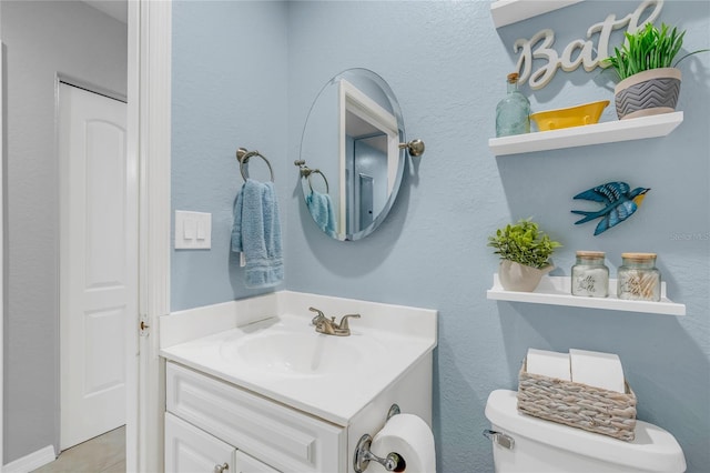 bathroom with vanity, tile patterned floors, and toilet