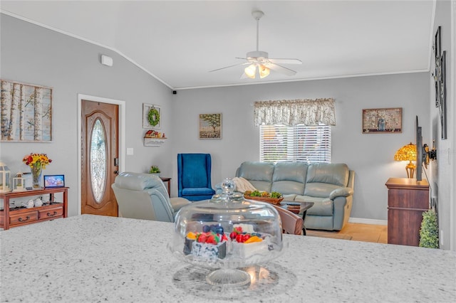 living room featuring lofted ceiling, ceiling fan, and light tile patterned flooring