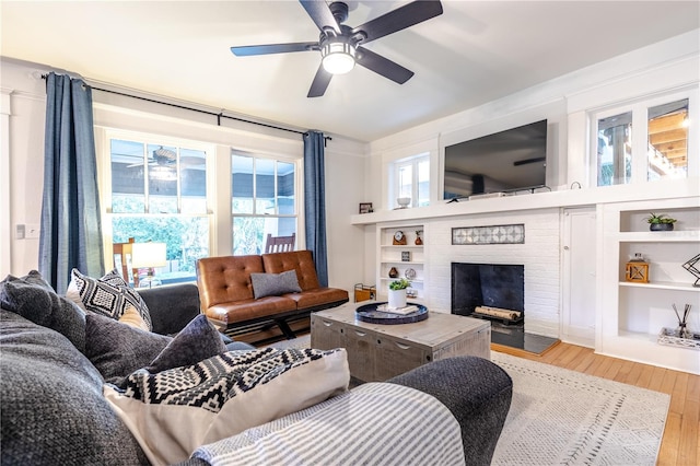 living room featuring a fireplace, a healthy amount of sunlight, and hardwood / wood-style flooring