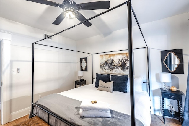 bedroom with ceiling fan and wood-type flooring