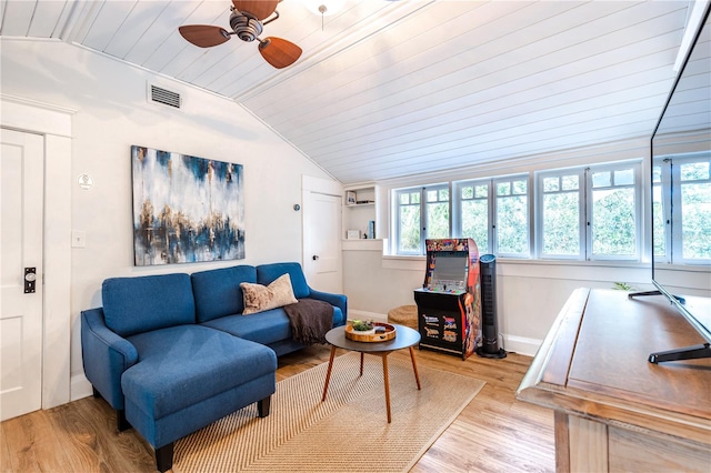 living room featuring ceiling fan, vaulted ceiling, and light wood-type flooring