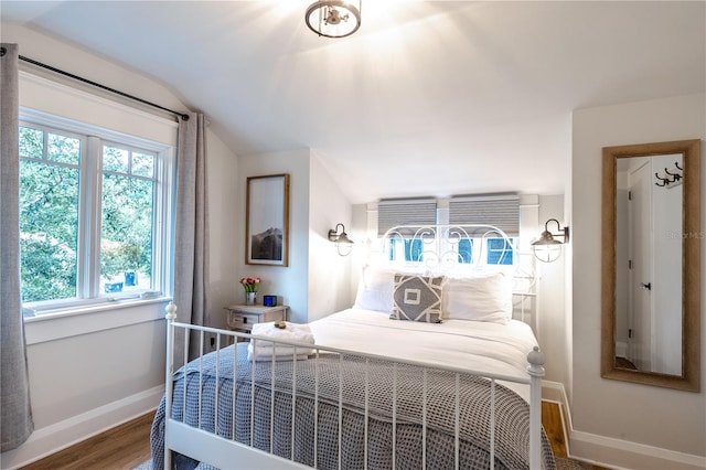 bedroom featuring lofted ceiling and wood-type flooring