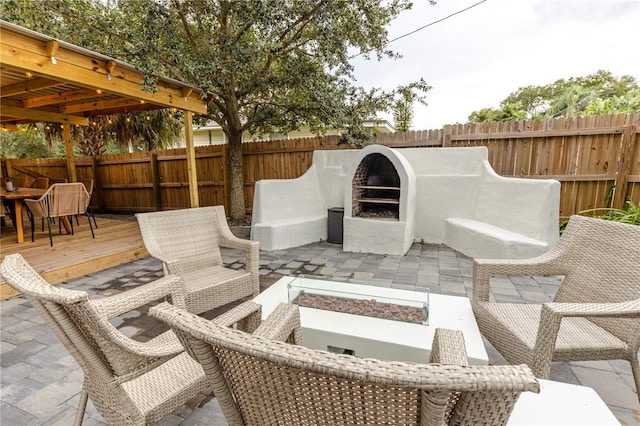 view of patio / terrace featuring a fire pit and a deck