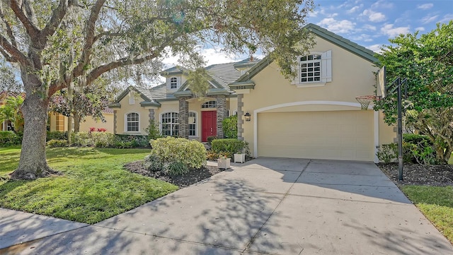 view of front of house with a garage and a front yard