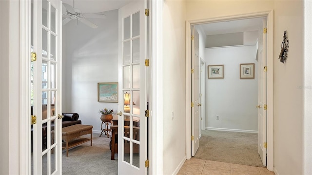 corridor with light carpet and french doors