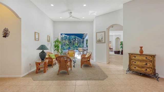 living area with ceiling fan and light tile patterned flooring