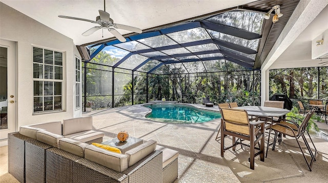 view of pool featuring a lanai, ceiling fan, a patio, and an outdoor hangout area