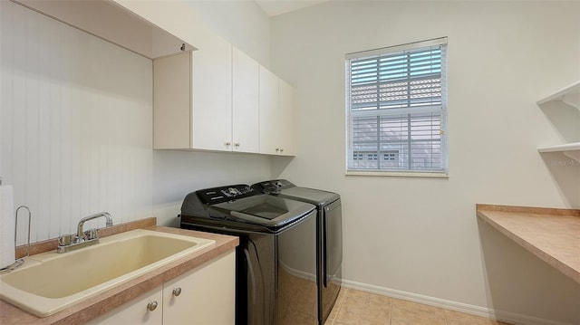 clothes washing area featuring cabinets, independent washer and dryer, sink, and light tile patterned floors