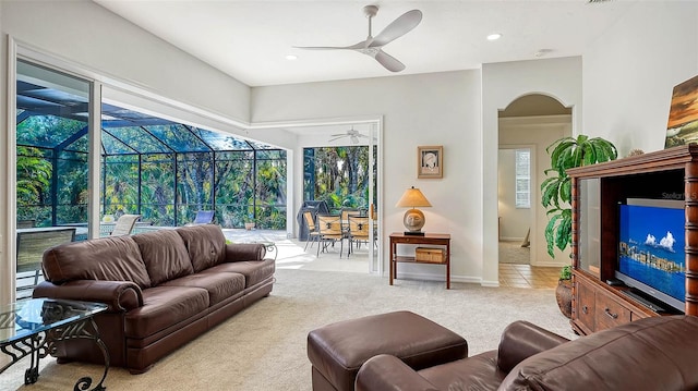 carpeted living room with a wealth of natural light and ceiling fan