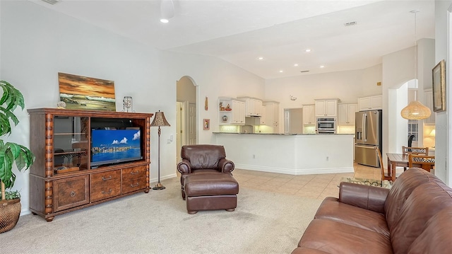 living room featuring light tile patterned floors and vaulted ceiling