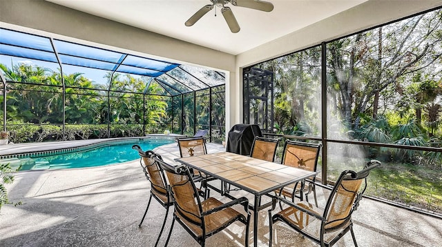 view of swimming pool with a lanai, a patio area, ceiling fan, and a grill