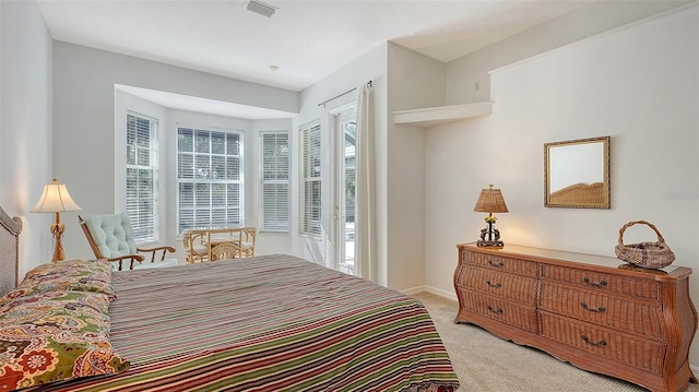 bedroom featuring access to outside and light carpet