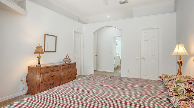 carpeted bedroom with connected bathroom