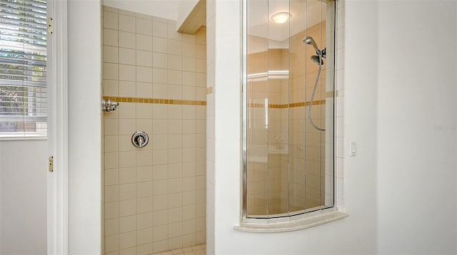 bathroom featuring a shower with door