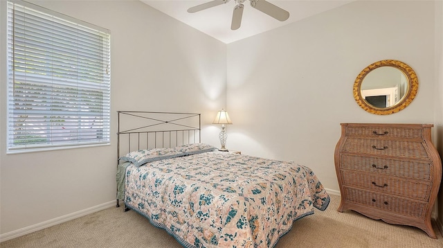 bedroom featuring light colored carpet and ceiling fan