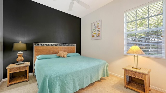 carpeted bedroom featuring ceiling fan and multiple windows