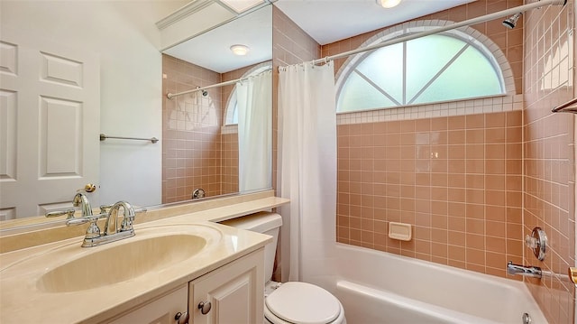 full bathroom featuring vanity, toilet, and shower / tub combo