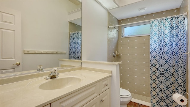 bathroom featuring vanity, toilet, and walk in shower